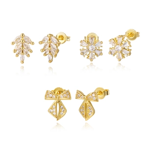 Close-up of 16K gold plated stud earrings set with leaf, snowflake and bow designs