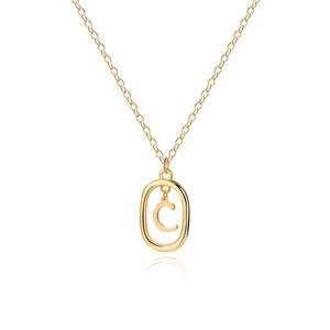 Macro detail of golden minimalist chain with an oval pendant featuring a movable letter C