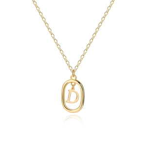 Macro shot of 18K gold letter D pendant with geometric oval frame on minimalist chain