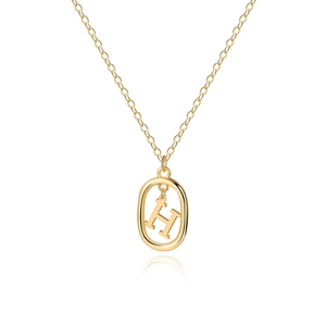 Detailed close-up of golden letter H pendant with oval frame and fine cross chain link