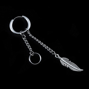 Detail view of silver hoop earring featuring dangling chain and intricate feather pendant
