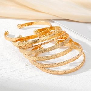 7pcs gold layered bracelet set with embossed geometric patterns and twisted rope texture