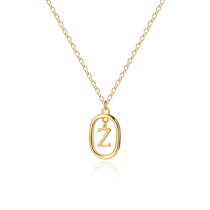 Detailed macro view of minimalist gold letter Z pendant on a fine link chain with reflection
