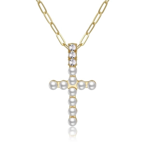 Close-up of golden paperclip chain necklace with a pearl cross pendant and zircon inlay