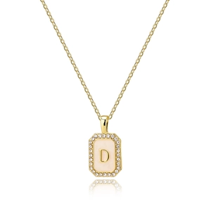 Detail of square gold pendant necklace with letter D and cubic zirconia frame