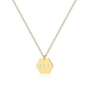 Detailed macro of 18K gold hexagonal pendant featuring hollowed 444 angel number design