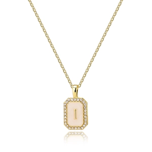 Detailed close-up of gold rectangle shell pendant with letter I and zircon stones