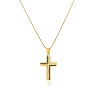 Macro shot of gold cross pendant with black and white rhinestones and snake chain link