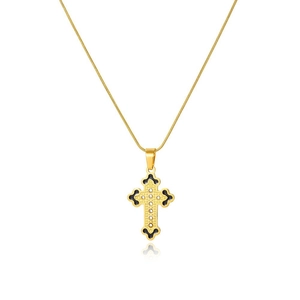 Macro detail of gold cross pendant with snake chain and black enamel accents