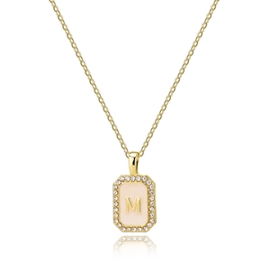 Detail of gold necklace with square M letter shell pendant and zircon stones