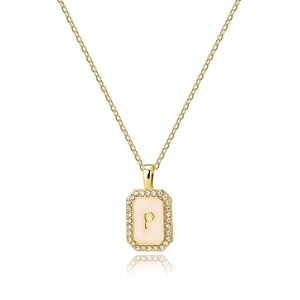 Macro detail of gold letter P pendant with sparkling zircon and white enamel shell