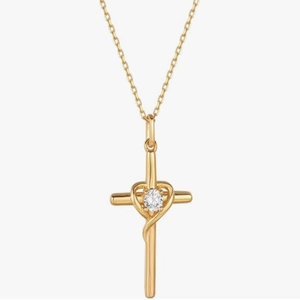 Detail of 18k gold cross heart pendant with a sparkling center stone on a fine chain