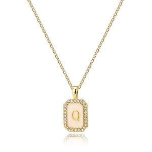 Macro shot of gold square pendant with pink enamel letter Q and zircon border inlay