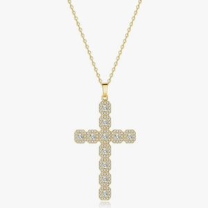 Macro shot of gold cross pendant with pavé set crystals on a delicate gold link chain