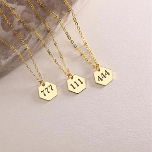 Golden angel number necklaces with 111, 444, and 777 engraved on hexagonal pendants