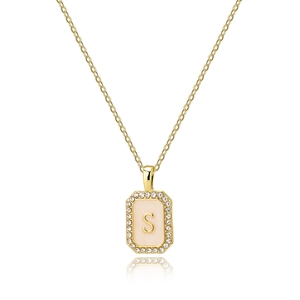 Detailed macro view of gold-plated square letter S pendant with pink enamel and zircons