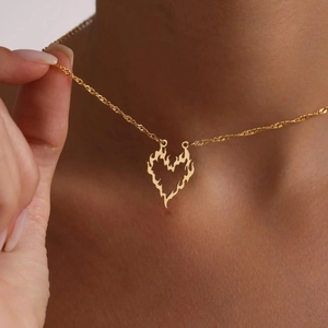Elegant gold-tone flame heart pendant necklace featuring a dainty twisted rope chain
