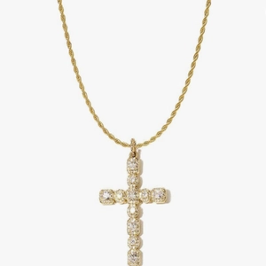 Detailed view of gold cross pendant with cubic zirconia on a twisted rope chain
