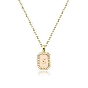 Macro view of gold octagonal pendant with shell inlay, zircon border and Z letter detail
