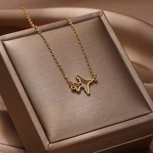 Gold hollow airplane pendant necklace displayed on a luxury brown jewelry gift box