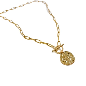 Gold paperclip chain necklace with a toggle clasp and irregular cross pendant