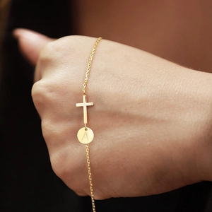 Gold cross bracelet for women with round initial A pendant on a delicate chain
