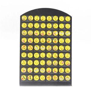 72-piece yellow emoji smile face stud earring set with various expressions on black board