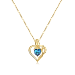 Detail of 18K gold heart necklace with blue gemstone and elegant rose accent