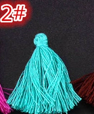 Macro detail of turquoise silk tassel with woven knot for DIY craft and garment decor