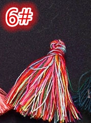 Macro shot of colorful handmade DIY craft tassels with braided rope knot for accessories
