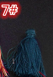 Close-up of deep teal silk tassel with woven top for DIY jewelry and bookmarks