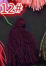 Close-up of deep purple cotton silk tassel for DIY bookmarks and craft accessories