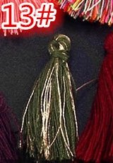 Detail of dark green tassel with gold thread accents for DIY crafts and accessories