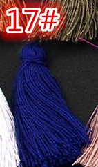 Detail showing various colors of handmade cotton tassels including royal blue and pink