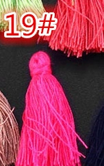 Detail of colorful DIY craft tassels with vibrant threads for bookmark decoration