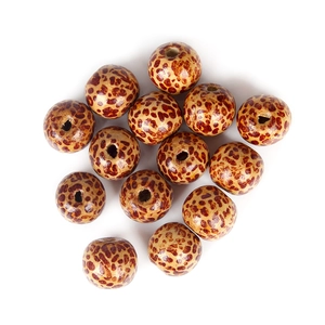 Close-up of 10mm wooden square beads with leopard print pattern for DIY jewelry making