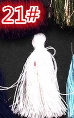 Detailed macro view of a white decorative silk tassel pendant for DIY craft projects
