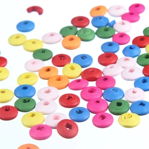 Detail of colorful round wooden spacer beads with central holes for DIY jewelry making