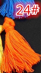 Macro view of blue and orange cotton tassels with decorative knots and silk threads