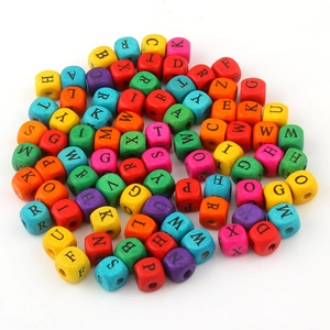 Macro view of colorful 10mm wooden square letter beads with printed alphabet for DIY jewelry