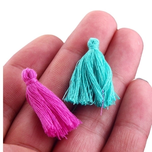 Miniature handmade silk tassels in vibrant pink and cyan for DIY jewelry making