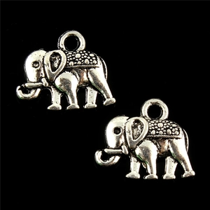 Macro view of two vintage silver elephant charms for DIY jewelry with detailed carvings