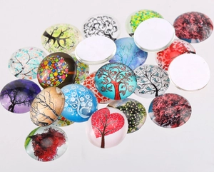 Macro detail of round glass dome cabochons with colorful tree of life art patterns