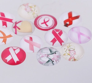 Flat lay of pink ribbon glass dome cabochons for jewelry making DIY supplies