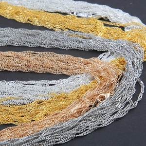 Gold, silver and rose gold water wave necklaces with lobster clasps on black background