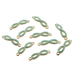 Close-up of golden infinity symbol charms with blue beads for DIY jewelry making