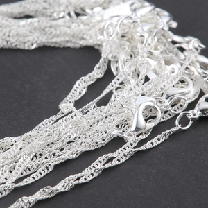 Detailed macro view of 925 sterling silver water wave chains with lobster clasps