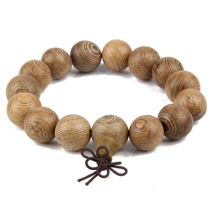 Detailed view of natural wooden prayer beads with unique grain and dark brown Chinese knot