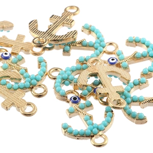 Golden alloy anchor charms with turquoise beads and evil eye detail for jewelry making