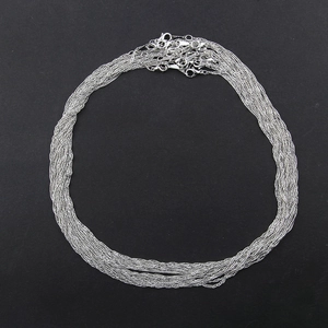 Detailed view of multiple silver water wave chains with lobster clasps for DIY jewelry